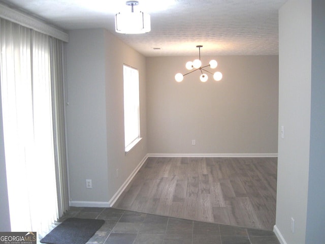 4383 Chestnut Lake Ave, Lithonia, GA 30038 - tiled empty room featuring a chandelier and baseboards