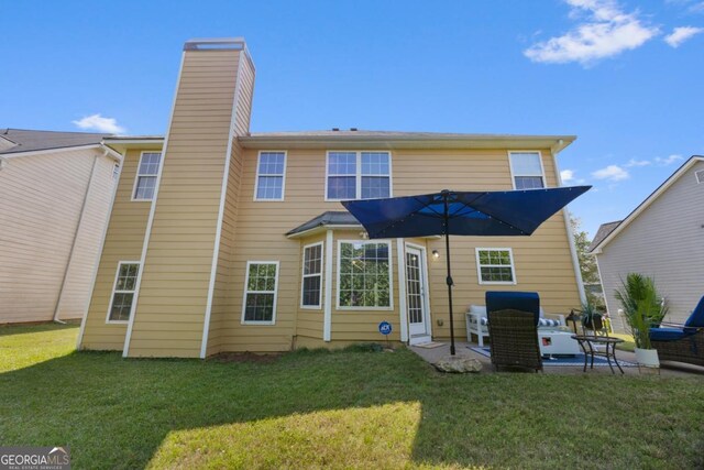 2584 Grayton Loop, Villa Rica, GA 30180 - back of house featuring a chimney, a patio, and a lawn