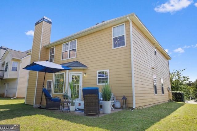 2584 Grayton Loop, Villa Rica, GA 30180 - back of property featuring a lawn, a chimney, and a patio area