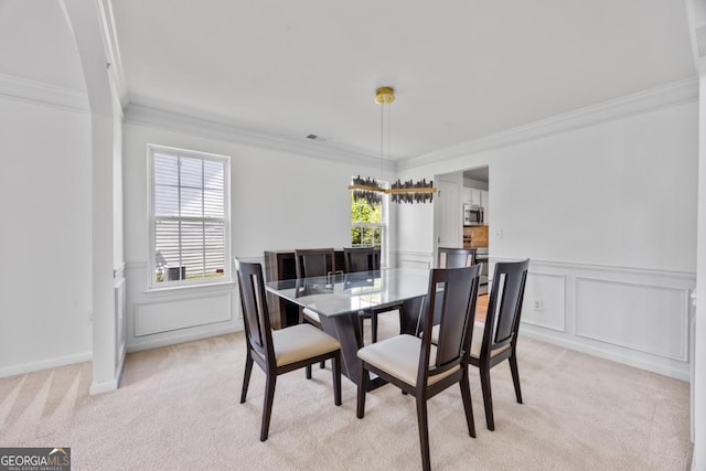 2584 Grayton Loop, Villa Rica, GA 30180 - dining space featuring light colored carpet, crown molding, a wainscoted wall, and a decorative wall