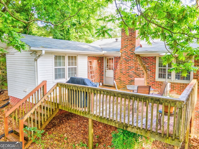 6 Greenleaf Dr SW, Rome, GA 30165 - view of front of home featuring a deck, brick siding, a shingled roof, and a chimney