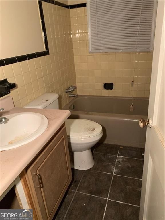 449 Hamilton E Holmes Dr NW, Atlanta, GA 30318 - full bathroom featuring vanity, toilet, tile patterned flooring, tile walls, and bathtub / shower combination