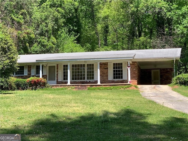 2703 Arrowood Dr, East Point, GA 30344 - ranch-style home with concrete driveway, a front yard, an attached carport, brick siding, and a porch