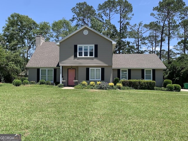 2242 Oakgrove Cir, Valdosta, GA 31602 - traditional-style house with a front yard, roof with shingles, and a chimney