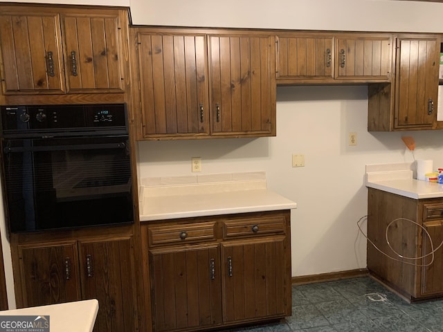 2242 Oakgrove Cir, Valdosta, GA 31602 - kitchen featuring black oven, light countertops, and baseboards
