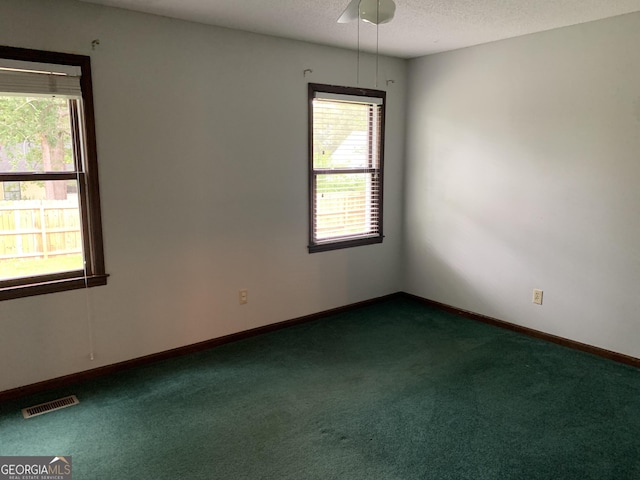 2242 Oakgrove Cir, Valdosta, GA 31602 - unfurnished room with dark colored carpet, a textured ceiling, and baseboards