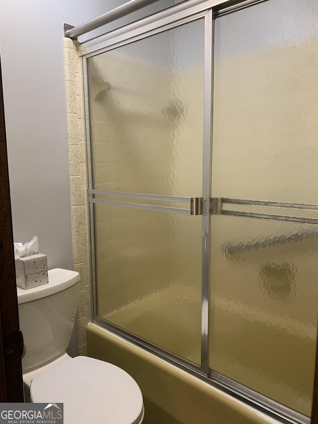2242 Oakgrove Cir, Valdosta, GA 31602 - full bath featuring toilet and combined bath / shower with glass door