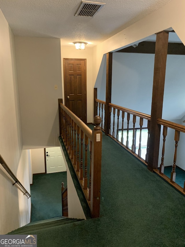 2242 Oakgrove Cir, Valdosta, GA 31602 - staircase featuring carpet floors and a textured ceiling