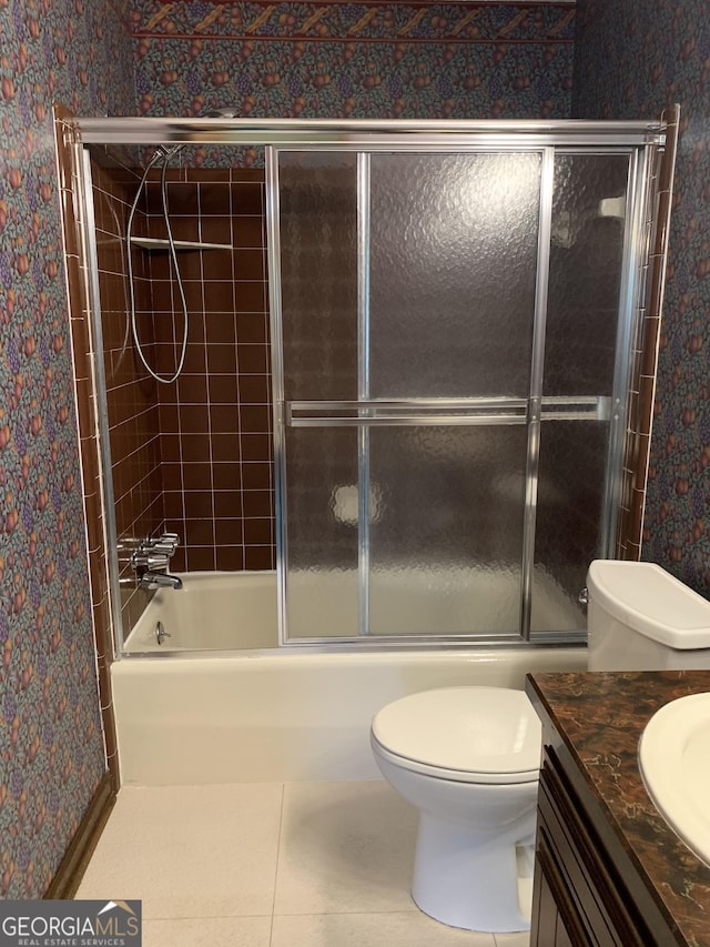 2242 Oakgrove Cir, Valdosta, GA 31602 - full bathroom with wallpapered walls, toilet, bath / shower combo with glass door, vanity, and tile patterned flooring