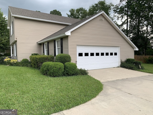2242 Oakgrove Cir, Valdosta, GA 31602 - view of front of home featuring driveway, a front yard, a garage, and roof with shingles