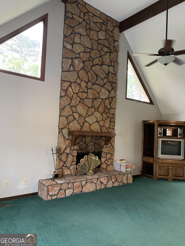 2242 Oakgrove Cir, Valdosta, GA 31602 - unfurnished living room with carpet floors, a stone fireplace, ceiling fan, beam ceiling, and high vaulted ceiling