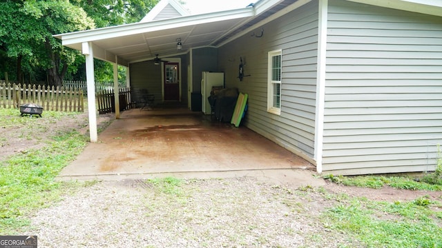 16156 Barnesville St, Zebulon, GA 30295 - view of parking featuring an attached carport, a ceiling fan, and driveway