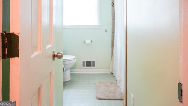 16156 Barnesville St, Zebulon, GA 30295 - bathroom with toilet, tile patterned floors, and baseboards