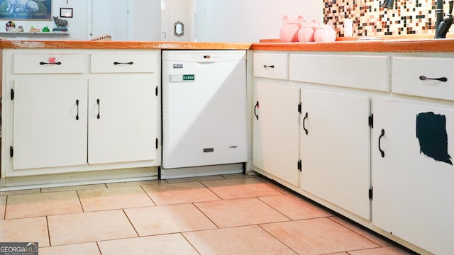 16156 Barnesville St, Zebulon, GA 30295 - kitchen with dishwasher, white cabinetry, light countertops, and light tile patterned floors
