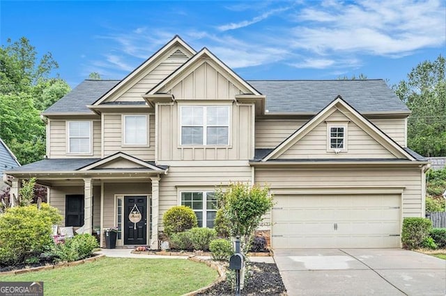 230 Haleys Ct, Woodstock, GA 30188 - view of front facade with driveway, board and batten siding, a front yard, and an attached garage