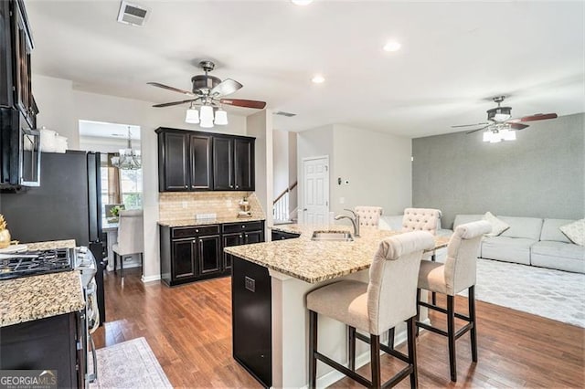 230 Haleys Ct, Woodstock, GA 30188 - kitchen with a ceiling fan, a kitchen breakfast bar, dark wood-style floors, open floor plan, and recessed lighting
