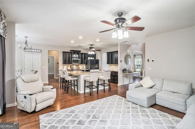 230 Haleys Ct, Woodstock, GA 30188 - living room with dark wood-style floors, recessed lighting, a chandelier, a ceiling fan, and baseboards