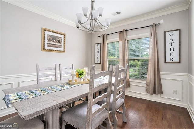 230 Haleys Ct, Woodstock, GA 30188 - dining room featuring a chandelier, crown molding, a wainscoted wall, dark wood-type flooring, and a decorative wall