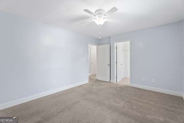 2067 Kinridge Ct, Marietta, GA 30062 - unfurnished bedroom featuring baseboards, light carpet, a spacious closet, and ceiling fan