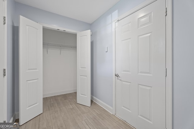 2067 Kinridge Ct, Marietta, GA 30062 - unfurnished bedroom with baseboards, a closet, and light wood-type flooring