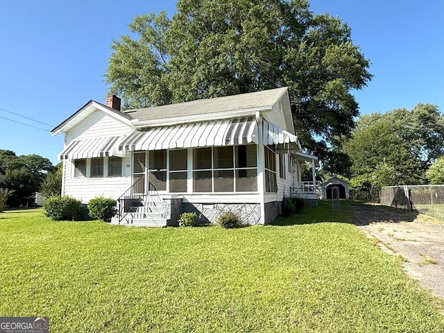 132 Carey St, Elberton, GA 30635 - view of front of home with a chimney, a front lawn, roof with shingles, and entry steps