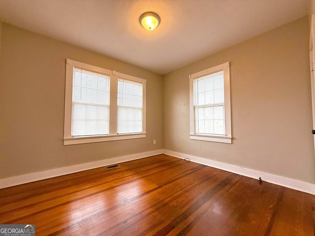 132 Carey St, Elberton, GA 30635 - empty room featuring baseboards and dark wood-style flooring