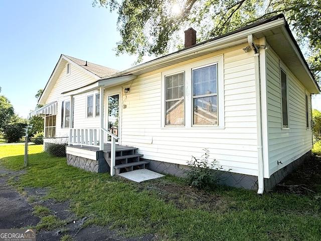132 Carey St, Elberton, GA 30635 - view of front of house featuring a chimney and a front lawn