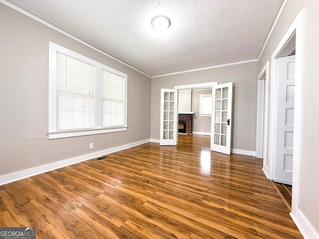 132 Carey St, Elberton, GA 30635 - spare room featuring ornamental molding, french doors, wood finished floors, baseboards, and a textured ceiling