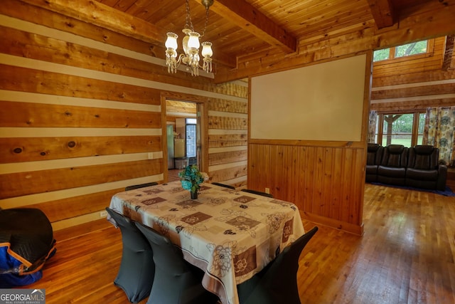 2905 Cammie Wages Rd, Dacula, GA 30019 - dining area with wood walls, wood ceiling with exposed beams, a chandelier, and hardwood / wood-style floors
