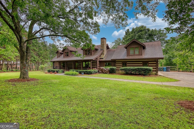 2905 Cammie Wages Rd, Dacula, GA 30019 - log-style house featuring log siding, a chimney, and a front yard