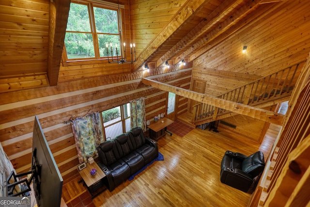2905 Cammie Wages Rd, Dacula, GA 30019 - living area with wooden walls, healthy amount of natural light, wood finished floors, and a chandelier