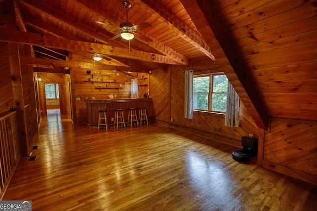 2905 Cammie Wages Rd, Dacula, GA 30019 - unfurnished living room featuring wood ceiling, hardwood / wood-style flooring, wooden walls, and a bar