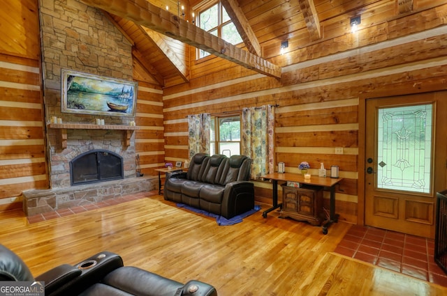 2905 Cammie Wages Rd, Dacula, GA 30019 - living room with a skylight, wood ceiling, wood finished floors, wood walls, and a stone fireplace