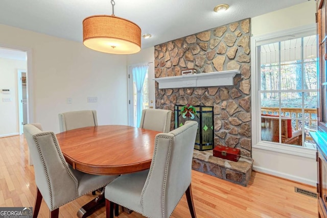 32 N Muscogee Dr, Ellijay, GA 30540 - dining area with wood finished floors, a fireplace, and plenty of natural light