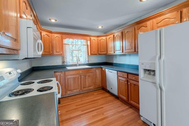 32 N Muscogee Dr, Ellijay, GA 30540 - kitchen with white appliances, light wood-style flooring, dark countertops, recessed lighting, and brown cabinets