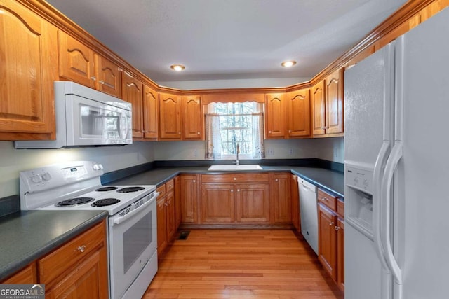 32 N Muscogee Dr, Ellijay, GA 30540 - kitchen with white appliances, dark countertops, light wood-style floors, brown cabinetry, and recessed lighting