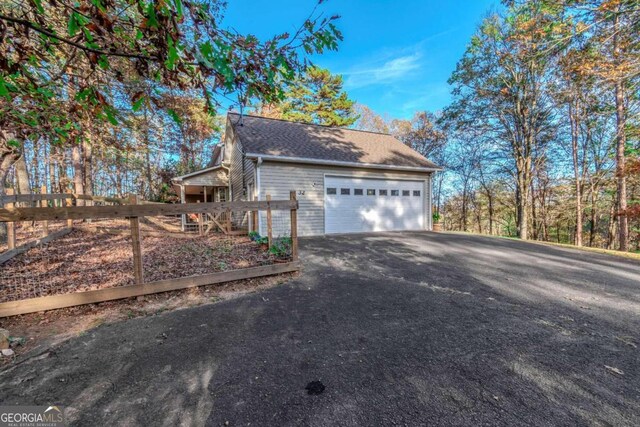 32 N Muscogee Dr, Ellijay, GA 30540 - view of home's exterior with driveway and roof with shingles