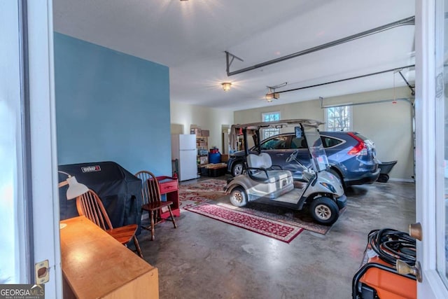 32 N Muscogee Dr, Ellijay, GA 30540 - garage featuring freestanding refrigerator and a garage door opener