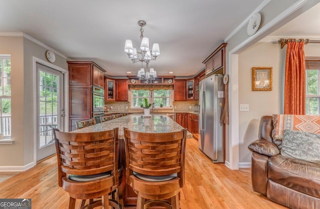 4441 Manning Mill Rd, Summerville, GA 30747 - kitchen with stainless steel appliances, a chandelier, baseboards, light stone counters, and ornamental molding