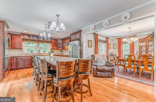 4441 Manning Mill Rd, Summerville, GA 30747 - dining room featuring a chandelier, light wood-type flooring, and ornamental molding