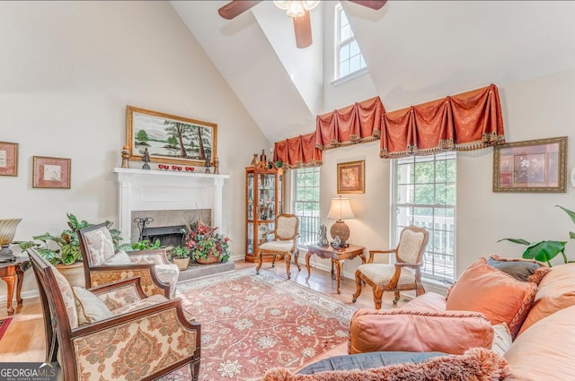 4441 Manning Mill Rd, Summerville, GA 30747 - living room featuring high vaulted ceiling, ceiling fan, a fireplace with raised hearth, wood finished floors, and baseboards