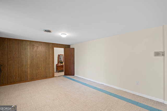 24 Brookside Dr, Newnan, GA 30263 - empty room featuring wood walls, baseboards, and light tile patterned flooring