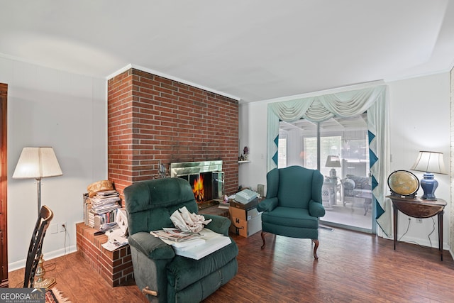 24 Brookside Dr, Newnan, GA 30263 - living area with wood finished floors, a brick fireplace, and crown molding