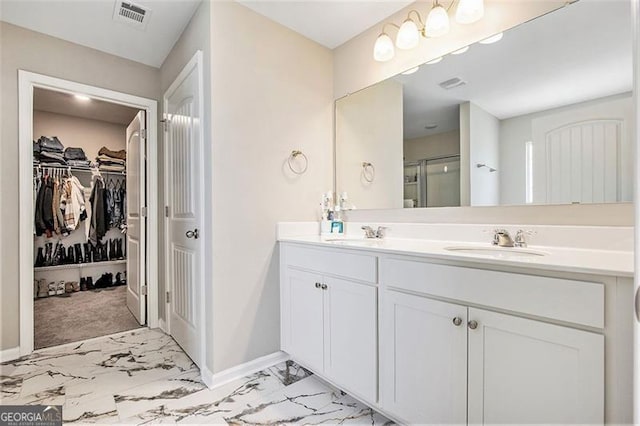 413 Huntleigh Shores Ln, Dallas, GA 30132 - full bathroom with double vanity, marble look tile flooring, a shower stall, and a walk in closet