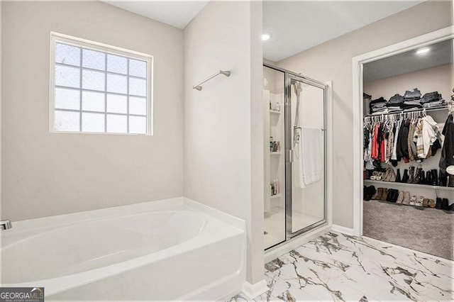 413 Huntleigh Shores Ln, Dallas, GA 30132 - full bathroom featuring a garden tub, a stall shower, a spacious closet, and marble look tile flooring