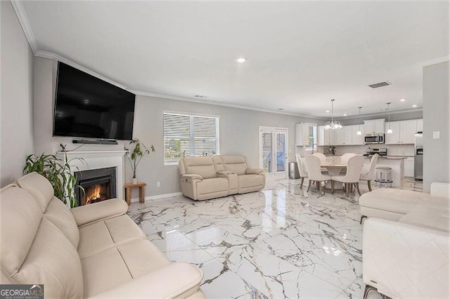 413 Huntleigh Shores Ln, Dallas, GA 30132 - living room with crown molding, healthy amount of natural light, recessed lighting, a chandelier, and a glass covered fireplace