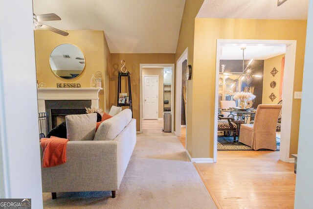 141 Simsbury Ln, Macon, GA 31220 - living area featuring vaulted ceiling, ceiling fan, a fireplace, and carpet floors