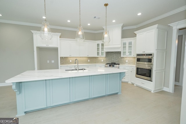 215 Jake Colton Dr, Kingsland, GA 31548 - kitchen featuring appliances with stainless steel finishes, a sink, a large island with sink, white cabinetry, and recessed lighting