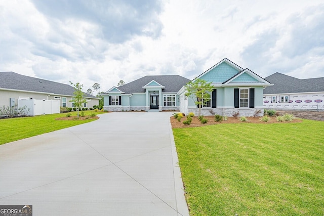 215 Jake Colton Dr, Kingsland, GA 31548 - view of front of property featuring stone siding, driveway, and stucco siding