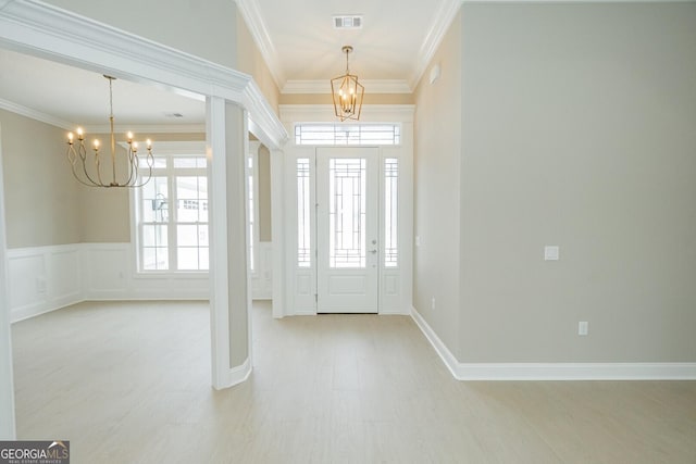 215 Jake Colton Dr, Kingsland, GA 31548 - foyer featuring a chandelier, ornamental molding, light wood finished floors, and wainscoting